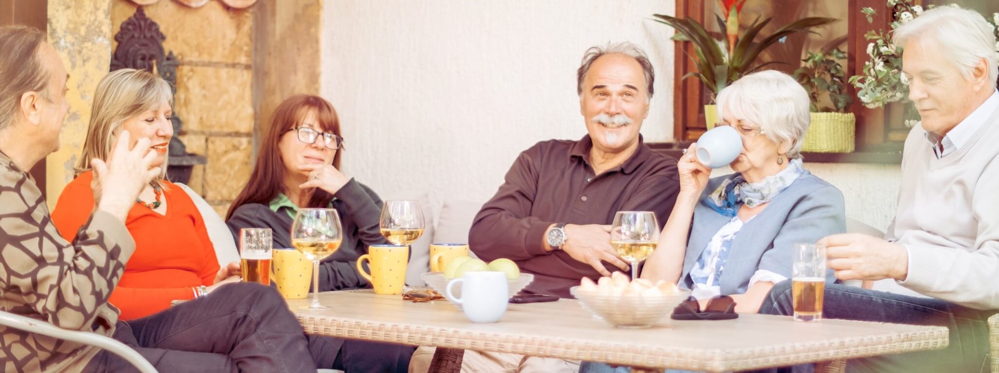 Group of five independent living residents gathered around a table